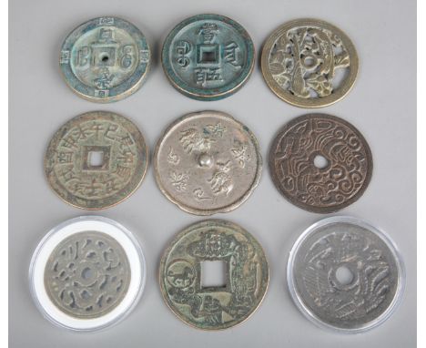 A COLLECTION OF CHINESE BRONZEWARE including coinage, bronze bi disks and a mirror in archaic style, the largest 7.5cm diamet