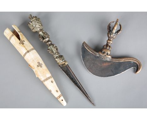 A TIBETAN BRONZE PHURBA19th/20th century, the three-sided blade with a vajra form handle and mask finial, 26.5cm long, with a