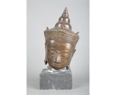 A THAI BRONZE BUDDHA HEAD Ayutthaya Kingdom (1351-1767), the face cast in a peaceful expression, figured wearing a crown deco