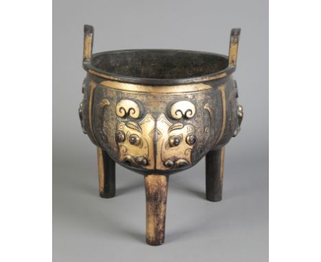 A CHINESE GILT BRONZE TRIPOD CENSER Qing dynasty, the trefoil shaped body with two ring handles to the rim and decorated in t