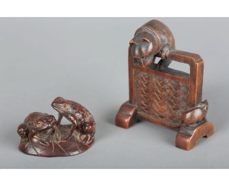 A JAPANESE CARVED WOOD OKIMONOsigned to the base, modelled as a cat chasing a mouse around a screen, 4.5cm high x 4cm wide; t