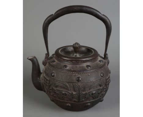 A JAPANESE BRONZE TETSUBIN OR KETTLE inscribed to the inside of the cover, decorated in the archaic style with taotie masks i