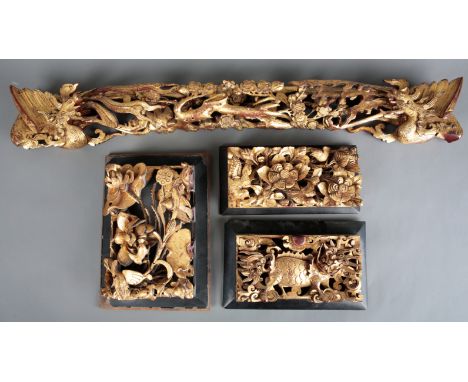A COLLECTION OF CHINESE GILTWOOD CARVINGSincluding a pelmet carved with phoenixes to each side, 78cm wide; and three similar 
