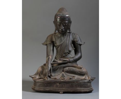 A BURMESE BRONZE BUDDHA Mandalay period, 19th century, cast seated in Vajrasana on a stepped pedestal base, with gem set band