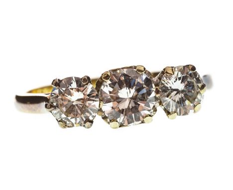 DIAMOND THREE STONE RING, the central round brilliant cut diamond of approximately 0.75 carats, flanked by two smaller diamon