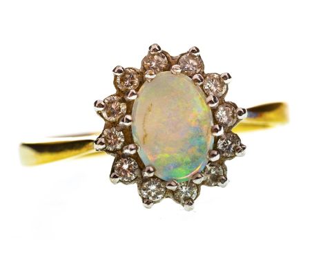 OPAL AND DIAMOND CLUSTER RING, set with a central oval cabochon cut opal 7.5mm long within a diamond halo, in eighteen carat 