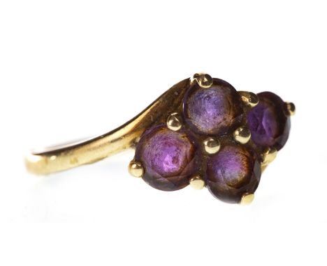 PURPLE GEM SET RING, the 15mm wide bezel set with four round purple gems, in nine carat gold, size R, 2.8g