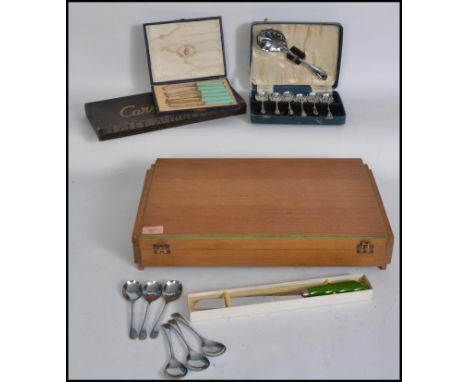 A vintage 20th century cased Art Deco style cased canteen of cutlery, hinged case opening to reveal a baize lined interior wi