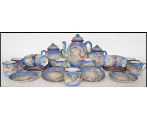 An Oriental ceramic 12 person eggshell tea service having a dragon decoration.