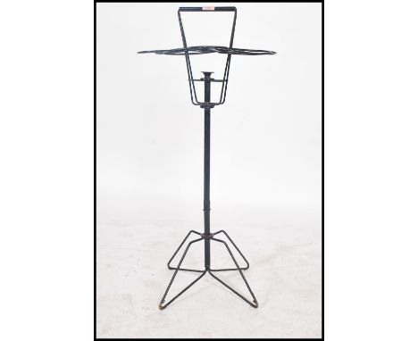 A vintage 20th century advertising point of sale florist bouquet flower holder of ebonised tubular construction raised on a q