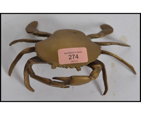 A vintage mid 20th century brass nautical novelty ashtray in the form of a crab having lift up lid to tray with removable com