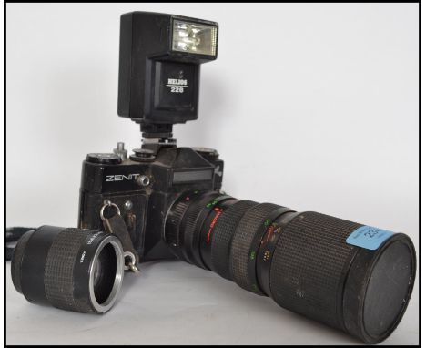 A vintage mid 20th century Zenit 35mm camera and lenses together with a vintage film viewer.