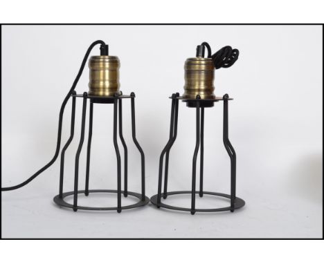 A pair of vintage industrial style pedant ceiling cage lights, black wire work cages with attached ceiling rose.
