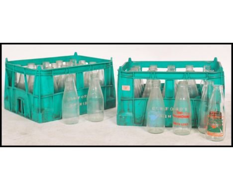 A collection of vintage and retro advertising and plain milk bottles for Dunsford dairies dating from the 1960's within origi