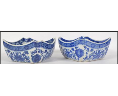 A pair of 19th / 20th century Chinese Oriental blue and white ceramic bowls, decorated with fauna and in the Kangxi style.