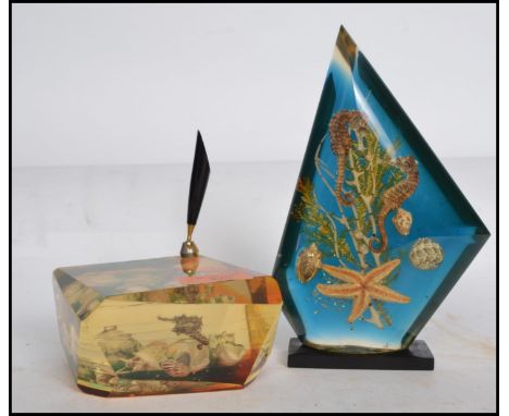 A vintage retro 20th century Dunhill inspired &nbsp;acrylic Lucite paperweight encasing an arangment of seahorses, star fish 