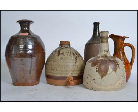 A good group of vintage 20th century studio pottery to include an Ewenny jug, vases, believed Tremar corked drinks vessels et