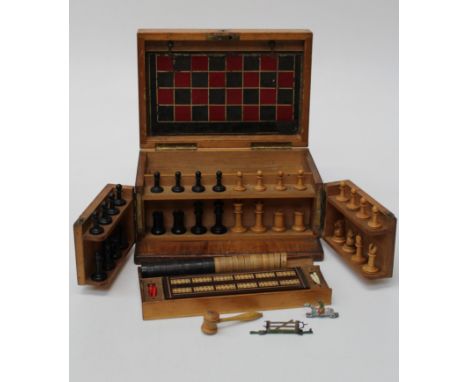 An Edwardian mahogany veneer games compendium, fitted with folding games board, chessmen and draughts, cribbage board, lead s