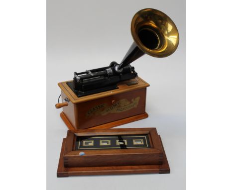 A late 20th century radio/cassette player, fashioned as a phonograph, together with a servent bell indicator board, 41cm wide