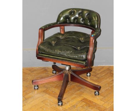 A late 20th century green button hide upholstered Captain's type swivel armchair