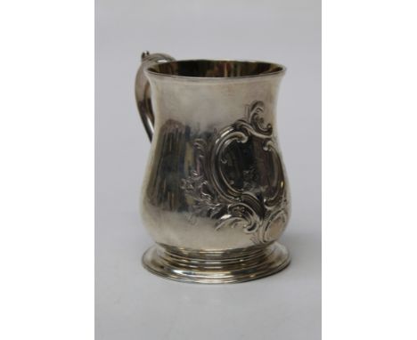 A George III silver tankard of baluster form, with leaf capped scroll handle, fine gilt interior, crested Rococo cartouche on