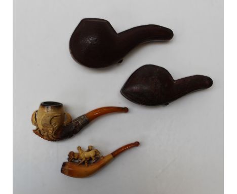 Two early 20th century cased Meerschaum pipes, one carved with hunting dogs, the other with eagle's talon