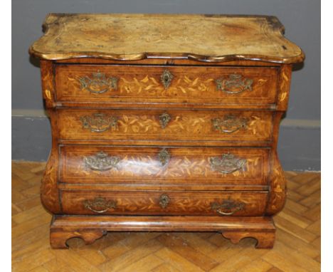 An early 19th Century Dutch floral marquetry bombe commode of small proportions, the serpentine top over four long drawers, r