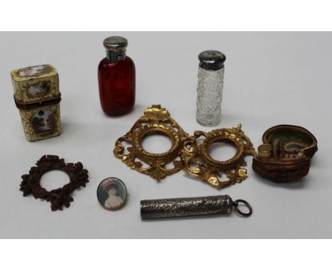 A 19th century enamel cased etui, 7cm, a walnut shell etui, a ruby glass scent bottle with white metal cap, a 19th century il