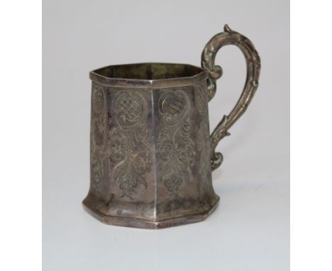 A Victorian silver Christening mug of Octagonal mug of octagonal form, with chased decoration and leaf cast scroll handle. Ma