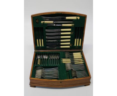 A 1930's oak canteen containing a six place setting of EPNS flatware and cutlery, carving tools etc