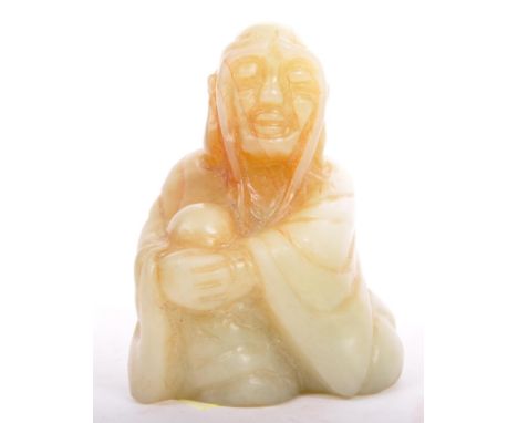 A 20th century, small carved Chinese, Oriental green jade sitting figurine. Figure approx. 5.5cm (height).