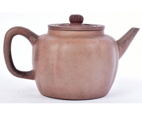 A believed 18th century Chinese Yixing earthenware teapot and cover. Bearing Kangxi floral mark to base. With original infuse