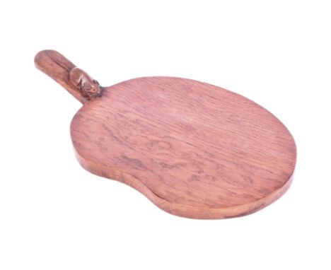 Robert 'Mouseman' Thompson of Kilburn (1876 - 1955) - a carved dark oak cheeseboard in kidney form, with a trademark mouse ca