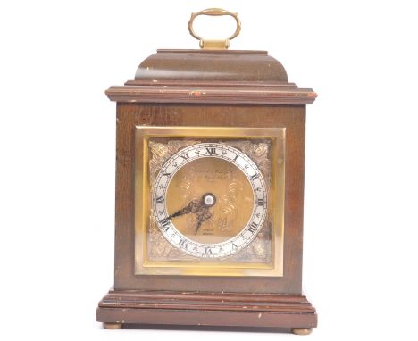 A vintage 20th century oak cased Garrard mantel clock with silvered face with roman numeral to the chapter ring. The clock fa