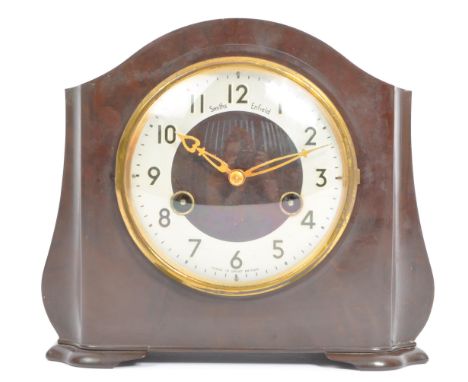 An early 20th century Smiths, Enfield British Bakelite eight 8 day mantel clock. Having an arched top with silver face ebonis