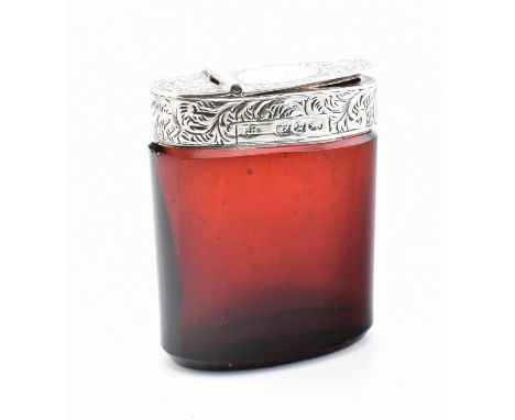A Victorian hallmarked silver mounted ruby glass vesta case. The case having a chased decorated top with a blank cartouche an
