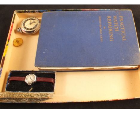 A lady's Acme Junion wristwatch, Ingersoll Triumph pocket watch, a watch repair book plus a Brass R.S.G.C. button