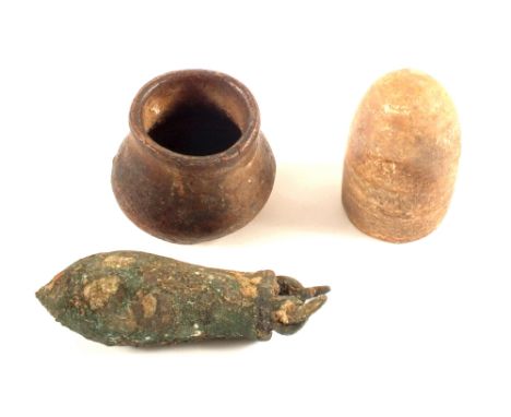 Three items of antiquity, a heavily patinated hollow metal item with suspension loops (possibly a plumb Bob), a small crudely