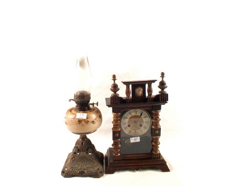 A mantel clock, oil lamp plus a print of the Crucifixion 