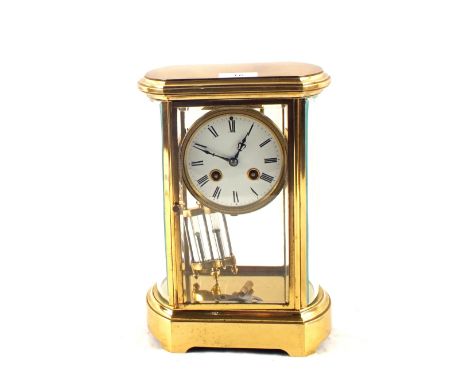 A French Brass four glass panel clock with mercury pendulum and enamel dial