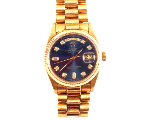 A gents 18ct Gold Rolex Oyster Perpetual Day-Date Superlative Chronometer wristwatch on President bracelet, blue dial set wit