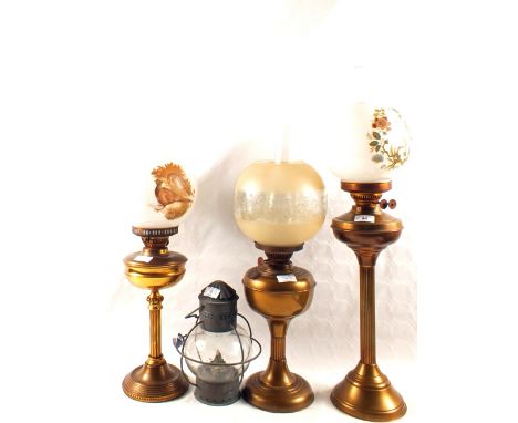 Three various Brass oil lamps plus a storm lantern