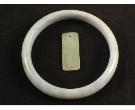 A Chinese Jade pendant with calligraphy and a bangle 