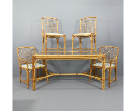 A 1970s bamboo dining table with inset glass top, and four matching dining chairs (2+2). W152, H76cm, D89cm.Upholstered in El