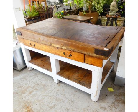 A vintage pine butcher's block on painted base. W153cm, H89cm, D92cm. Some signs of worm damage. The banding has expanded and