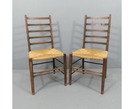 A pair of late 19th century Liberty and Company ladder-back side chairs with rush seats. 