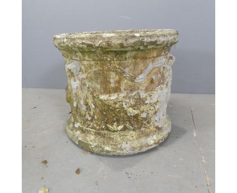 A weathered concrete circular planter, with cherub and swag decoration. D44cm, H40cm. 