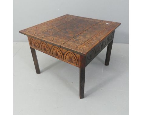 An Arts and Crafts style oak lamp / occasional table, with carved decoration. W55cm, H42cm, D56cm. 