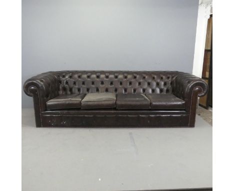 A modern button-back studded brown leather upholstered four-seated Chesterfield sofa. Overall: W250cm, H70cm, D90cm. Seat: W1