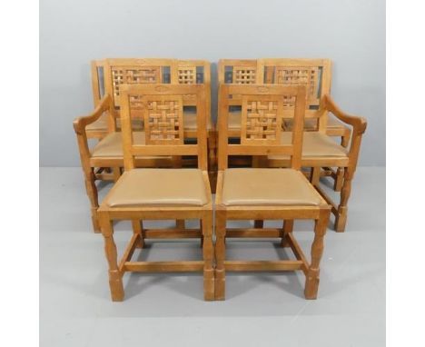 David "Oakleaf Man" Langstaff - A set of eight Yorkshire School Arts and Crafts oak dining chairs comprising six side chairs 